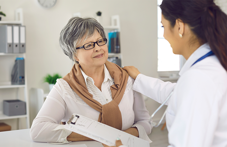 doctor with hand on patients shoulder