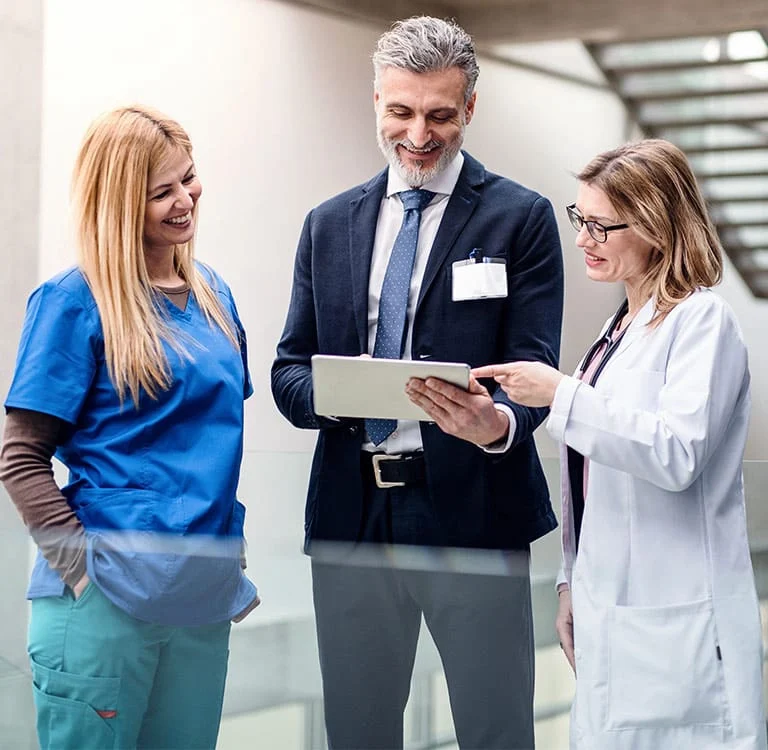 pharmaceutical and medical team members reviewing information on a tablet