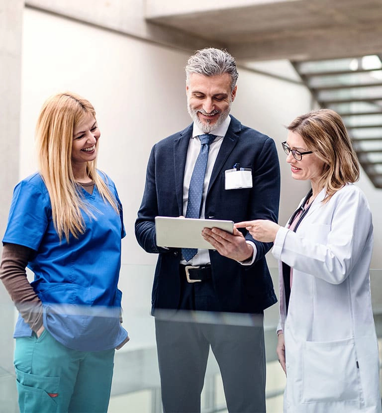 pharmaceutical and medical team members reviewing information on a tablet
