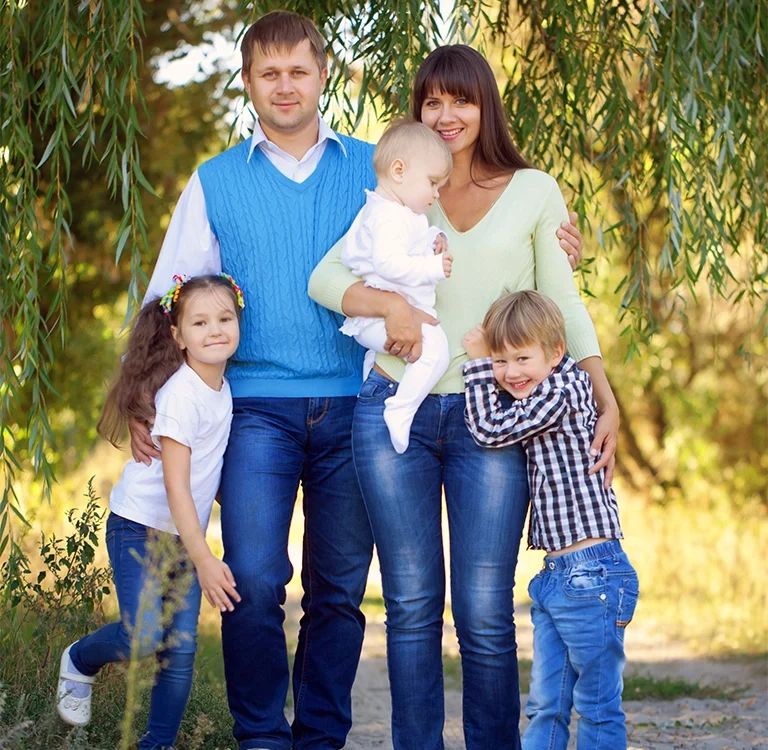 family standing together and smiling